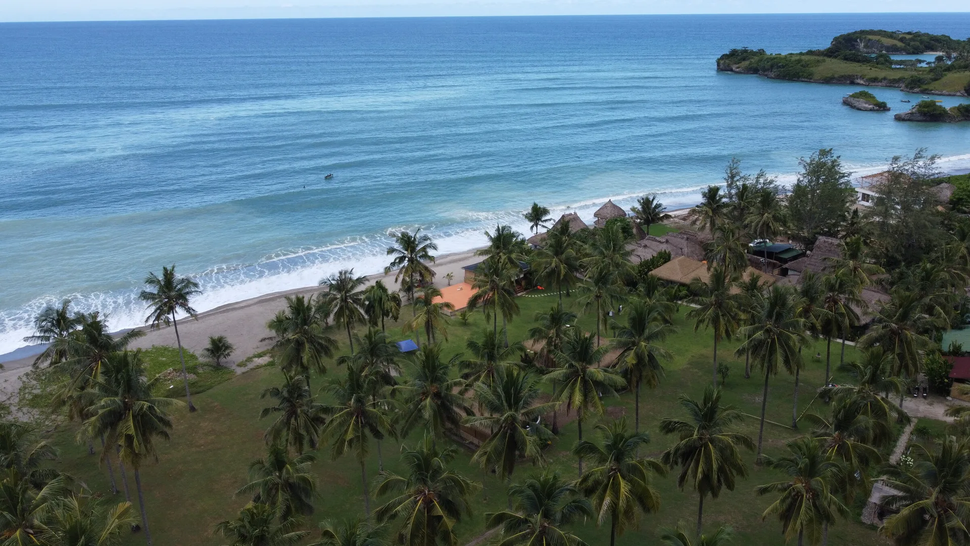 The Marapu villa among the palms above the beach, from the air